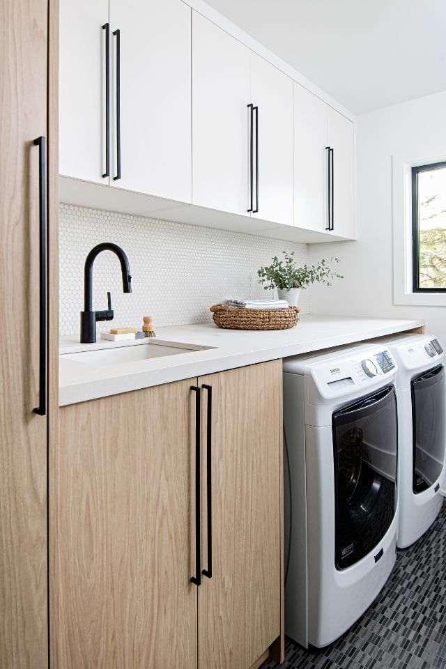 black and white laundry room with wood tones